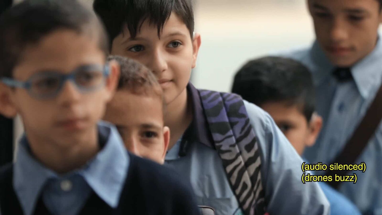 Children together; one signs to the others.